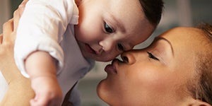 MOM KISSING BABY